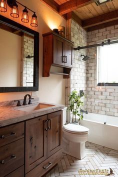 a bathroom with a toilet, sink and bathtub next to a window in it