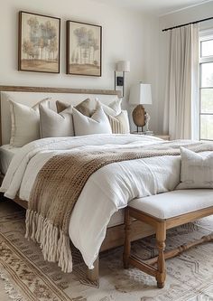 a large bed sitting next to a window in a bedroom on top of a rug