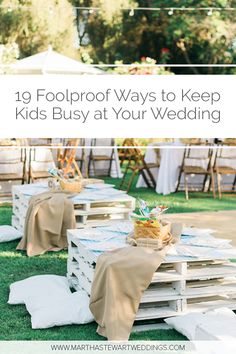 an outdoor wedding with wooden pallets and tables covered in burlocks, on grass