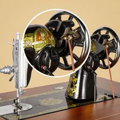 an old fashioned sewing machine with wheels and spokes attached to it's stand