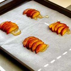 four slices of apple being cooked on a baking sheet