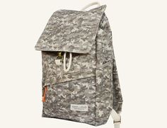 a gray backpack with white straps and an orange tag hanging from the front, on a white background