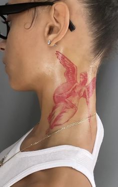 a woman with a tattoo on her neck