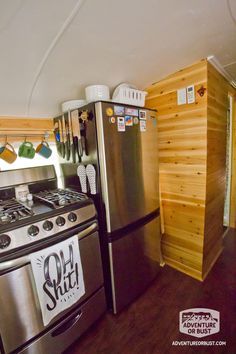 a stove top oven sitting inside of a kitchen next to a refrigerator freezer combo