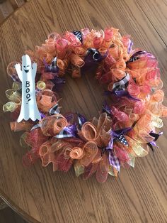 an orange and purple wreath on a table