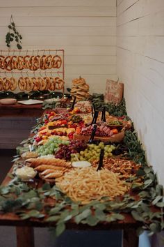 an assortment of food sitting on top of a table next to other foods and desserts