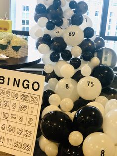 a table topped with black and white balloons