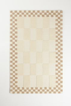 a beige and white rug with squares on it