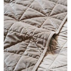 an image of a close up view of a quilted comforter on a bed