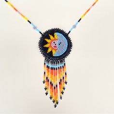 Unique And Authentic Eclipse Moon,Sun And Hearth Mexican Neklace Made With Very Good Quality Shakira Beads, Handmade In Zacatecas, Mexico By Mexican Huichol Artisans. With Your Purchase, We Thank You For Appreciating The Beautiful And Durable Pieces Of Art Made By Mexican Huichol Artisans And For Spreading Mexican Culture And Joy. Length 23” Approx Nico Y Autntico Collar Mexicano Eclipse Luna, Sol Y Tierra Hecha Con Cuentas De Chaquira De Muy Buena Calidad, Hecho A Mano Por Huicholes Artesanos E Bohemian Adjustable Sun Design Necklace, Adjustable Sun Design Necklace For Festivals, Bohemian Sun Design Necklace For Festivals, Bohemian Round Necklace With Sun Design, Festival Sun And Moon Design Round Necklace, Bohemian Sun Design Jewelry For Beach, Sun Moon Necklace, Lariat Style Necklace, Sun And Moon Necklace