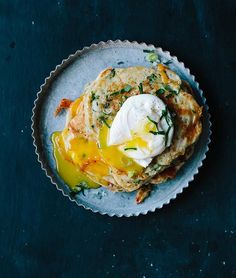 a plate topped with pancakes covered in an egg