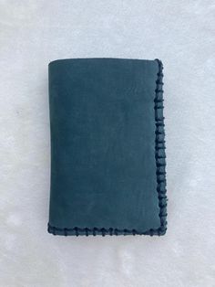 Authentic leather hand stitched wallet. Green suede leather and black stitching. Four card pockets and full sized cash pocket on the inside. Closes with a silver button. Created sustainably with secondhand leather. 100% handmade in Detroit, Michigan. Hand-stitched Trifold Wallet For Everyday Use, Hand-stitched Trifold Wallet, Everyday Hand-stitched Trifold Wallet, Hand-stitched Leather Trifold Wallet, Detroit Michigan, Silver Buttons, Money Clip Wallet, Green Suede, Stitching Leather