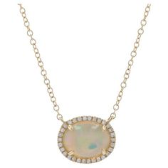 Metal Content: 14k Yellow Gold Stone Information: Natural Ethiopian Opal Carat: 1.02ct Cut: Oval Cabochon Size: 8.8mm x 6.9mm Natural Diamonds Carats: .07ctw Cut: Single Color: G Clarity: VS1 Total Carats: 1.09ctw Style: Attached Halo Pendant Chain Style: Cable Closure Type: Lobster Claw Clasp Pendant Measurements Tall: 3/8" (9.1mm) Wide: 7/16" (11.1mm) Necklace Measurements Length: 16" - 18" (adjustable) Width: 1/16" (1.1mm) Total Weight: 2.3 Grams Stamps: 14k, DA Condition: New without Tags Necklace Measurements, Halo Necklace, Halo Pendant, Gold Stone, Oval Cabochon, Halo Diamond, Ethiopian Opal, Chain Styles, Lobster Claw