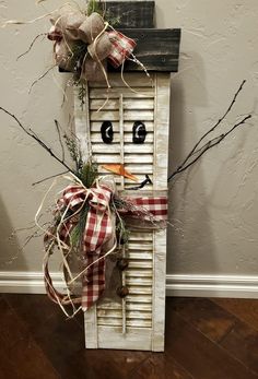 a snowman made out of an old shutter