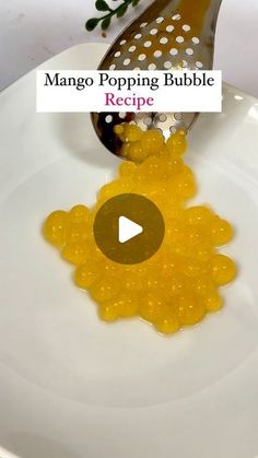 a video showing how to make mango poppin bubble recipe on a plate with a spoon