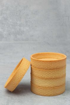 a stack of cookies sitting next to each other on top of a gray tablecloth