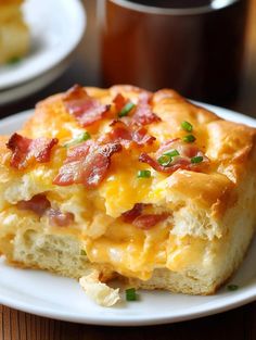 a piece of breakfast casserole on a plate with a cup of coffee in the background