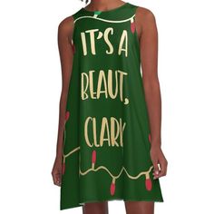 a girl wearing a green dress that says it's a beautiful clark on the front