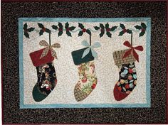 quilted christmas stockings hanging on a wall