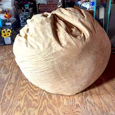 a large bean bag sitting on top of a wooden floor