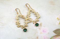 Emerald Green Laurel Leaf Earrings- Vine Earrings- Victorian Earrings- Art Deco Earrings- Bridal Earrings- Long Drop Earrings- Gift for Her Hanging from a quality Matt gold (over brass) Laurel leaf connector  are 5mm emerald green round crystals.  They suspend from Matt gold ear wires  2 inches long They arrive gift boxed with a bow Thanks for looking, Lori Art Deco Earrings Bridal, Vine Earrings, Victorian Earrings, Laurel Leaf, Deco Earrings, Earrings Art, Long Drop Earrings, Art Deco Earrings, Earrings Long