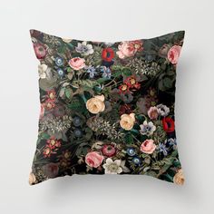 a black pillow with colorful flowers on it