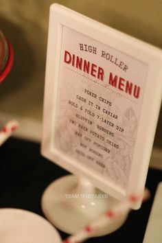 a table with a menu and wine glass on it