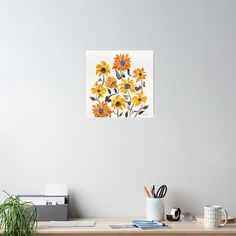 a painting of sunflowers on a white wall above a desk with office supplies