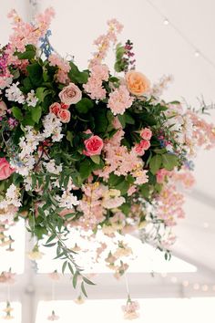 a bunch of flowers hanging from the ceiling