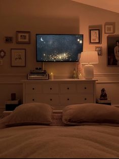 a bedroom with a large flat screen tv mounted to the wall