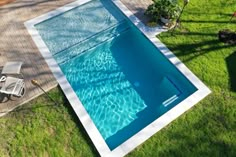 an aerial view of a swimming pool in the backyard