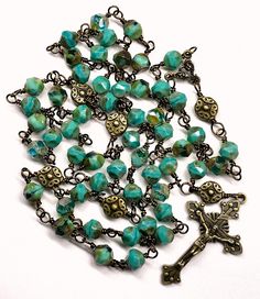 "This five decade Catholic Rosary is made with fifty-three beautiful rustic, earthy, 8 mm green Czech Glass Beads, and six larger Vintage Bronze Metal Beads. This rosary is considered unbreakable due to the wire wrapping technique I use (not a simple loop, but wrapped around). The crucifix is a 2 Inch Vintage Bronze Starburst Crucifix, and is beautifully detailed. The center is a bronze scrolled 3-way. Your Rosary will be shipped in an nice organza pouch, and will include a pamphlet \"How To Pra Vintage Adjustable Rosary With Round Beads, Vintage Adjustable Rosary, Handmade Artisan Rosary, Artisan Handmade Rosary, Wire Wrapping Techniques, Decade Rosary, Organza Pouch, Catholic Rosary, Rosary Catholic