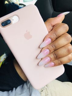 a woman holding an iphone case in her hand with pink and white nails on it