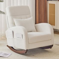 a white rocking chair in a living room