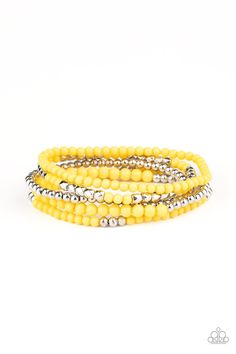 An array of decorative silver, polished yellow, and smooth silver beads are threaded along stretchy bands around the wrist, creating colorful layers. Cheap Yellow Festive Bracelets, Cheap Yellow Bracelets For Festive Occasions, Cheap Yellow Stretch Bangle Bracelet, Cheap Yellow Bohemian Beaded Bracelets, Cheap Yellow Statement Bracelet, Cheap Bohemian Yellow Beaded Bracelet, Yellow Beaded Bracelets, Yellow Bracelet, Stacked Jewelry