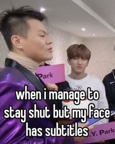 two men holding pink signs with the words when i manage to stay shut my face has subtitles