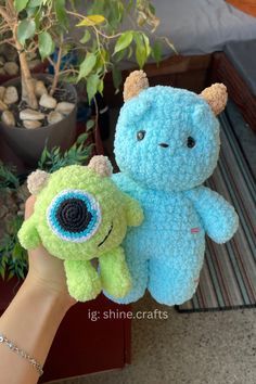 two handmade stuffed animals sitting next to each other