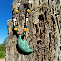 This knotted necklace has a wonderful African tribal vibe with it's green quartz, orange carnelian, white mother of pearl and brown wood color theme. The smiling Man in the Moon pendent made of green aventurine is believed to bring abundance, good luck and opportunity and completes the bohemian and overall masculine feel of this piece. Earthy Green Necklace For Festivals, Nature-inspired Green Necklace For Festivals, Nature-inspired Green Necklace For Festival, Earthy Green Necklace For Festival, Bohemian Aventurine Beaded Necklaces, Bohemian Aventurine Beaded Necklace, Adjustable Green Carved Necklace, Adjustable Green Carved Necklaces, Bohemian Hand-strung Jade Necklaces