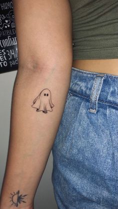 two people with tattoos on their arms and one has a ghost tattoo on the arm