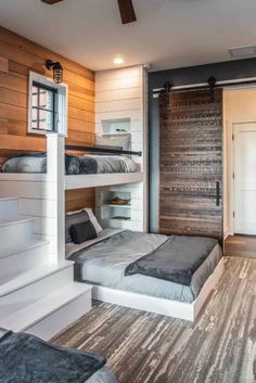 a bedroom with bunk beds and stairs leading up to the loft bed area in the room