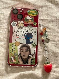 an iphone case with pictures and charms attached to it