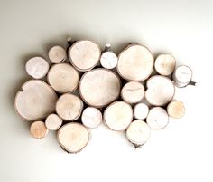 a pile of cut logs sitting on top of a white table next to each other