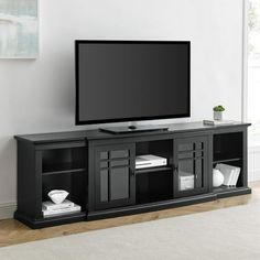 a flat screen tv sitting on top of a black entertainment center