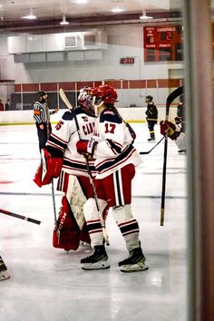 some hockey players are standing on the ice