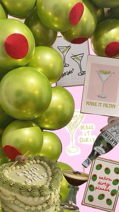 there are many green balloons and decorations on the table with wine glasses, cake, and other items