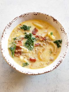 a white bowl filled with soup on top of a table