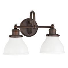 two light bathroom fixture in an antique bronze finish with frosted glass shades on the sides