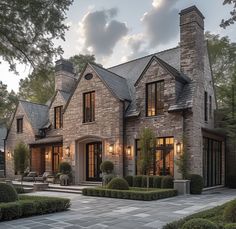 a large brick house with lots of windows and stone walkways in front of it