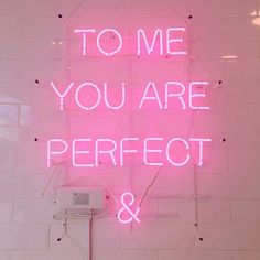 a pink neon sign that says to me you are perfect and