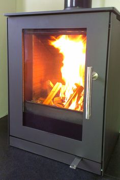 a wood burning stove with flames in it